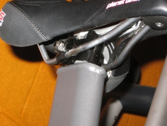 Closeup of the seat hardware, attached to an aftermarket seat.